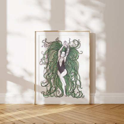 Framed artwork of a woman with flowing green hair on a white wall. A piece on our relationship with Mother Earth.