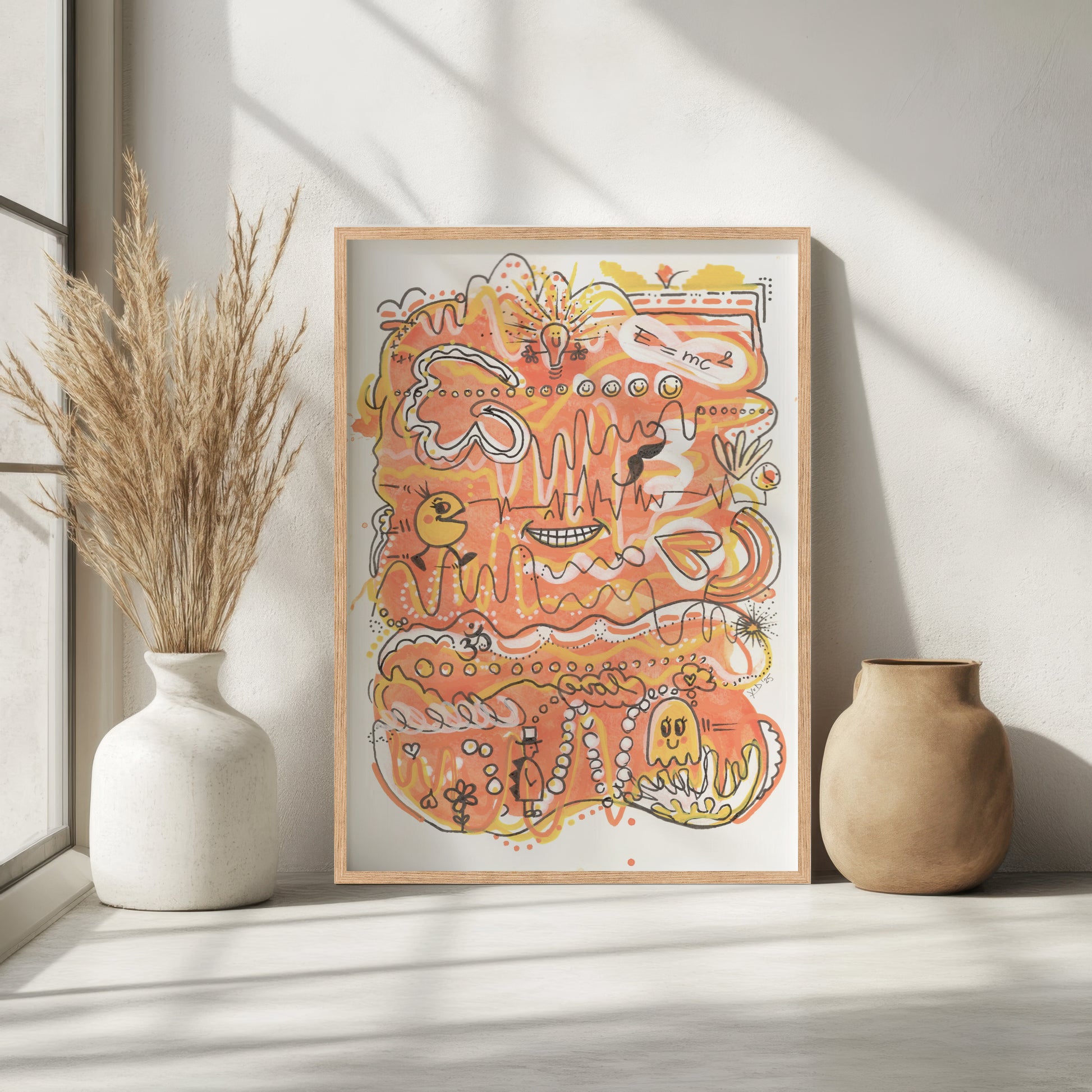 Framed abstract artwork with orange and yellow colors on a white wall, flanked by two vases. A piece on Energy and Positivity.