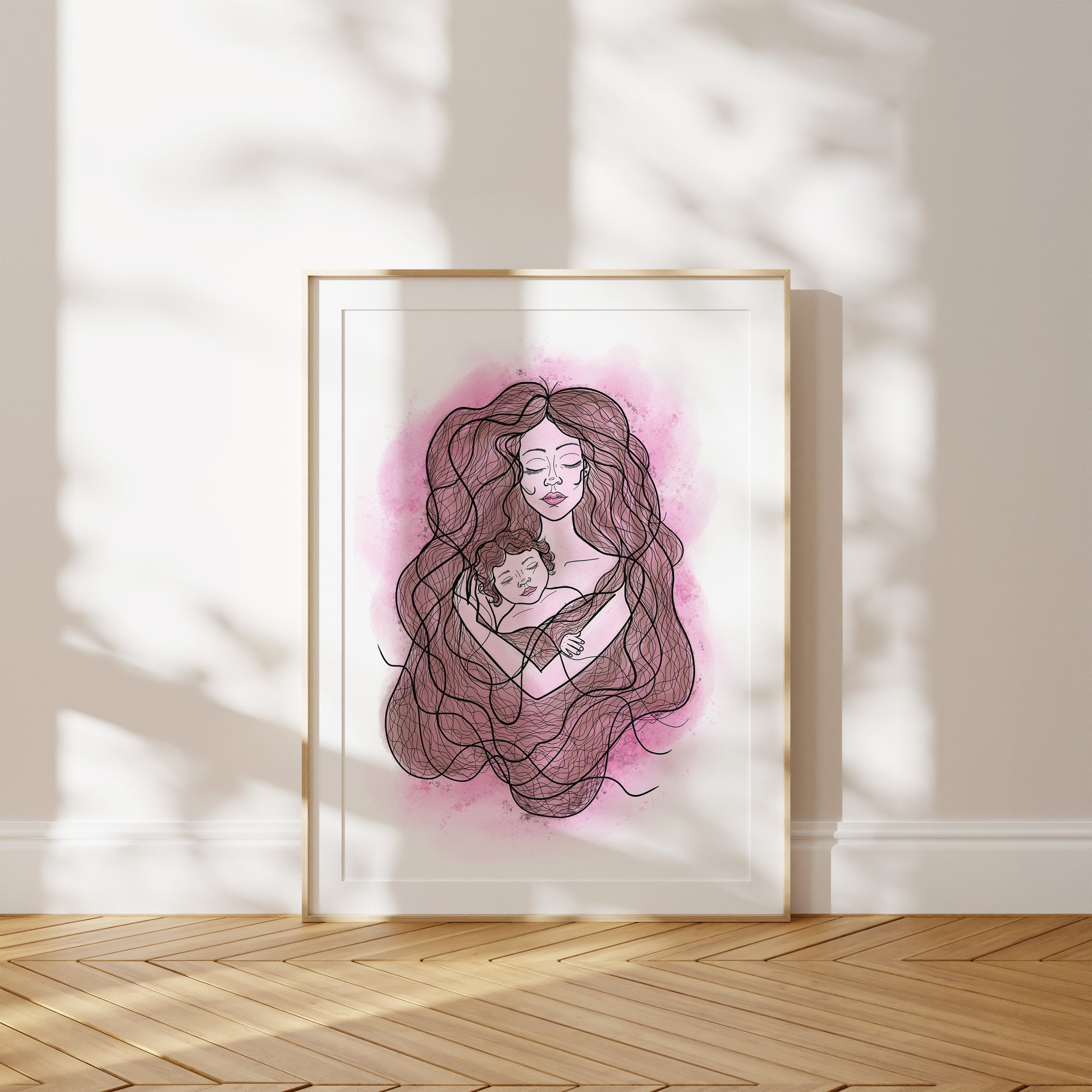 Framed artwork of a mother and child with pink blush effect on a white wall.